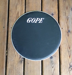 GOPE brand napa drum head, Black napa head with aluminum rim. Wood porch backdrop.