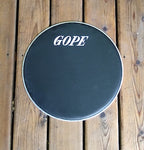 GOPE brand napa drum head, Black napa head with aluminum rim. Wood porch backdrop.
