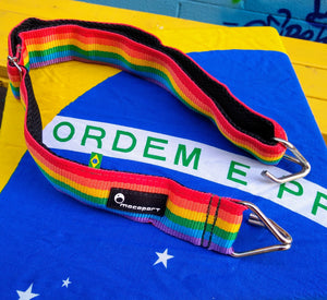 Rainbow waist strap for samba reggae. Macapart brand strap sitting on a Brazilian flag.