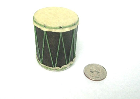 Tiny hand-made shaker that looks like a teeny drum with a quarter to compare the size. Goat skin heads and wood shell. Green strings.